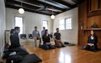 Meditation instructor Carri Garcia, right, led practitioners in a meditation and instruction session in the main meditation hall at the Minnesota Zen 