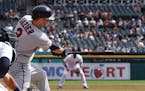 Minnesota Twins' Brian Dozier (2) hits a two-run single against the Detroit Tigers in the second inning of a baseball game in Detroit, Thursday, Sept.