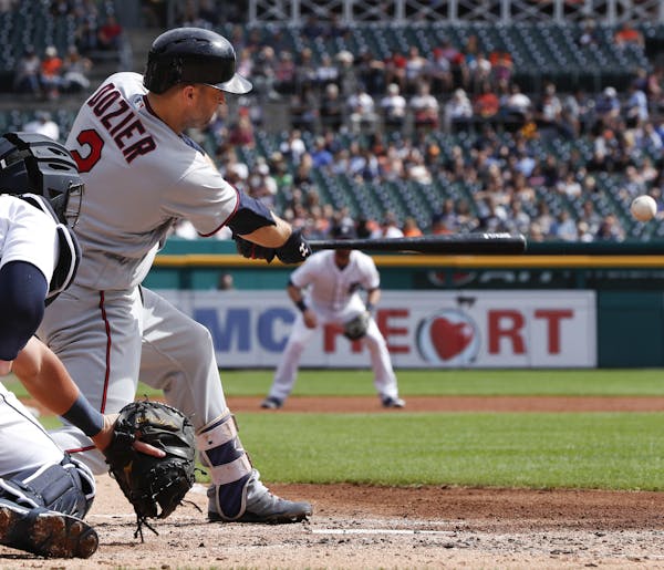 Minnesota Twins' Brian Dozier (2) hits a two-run single against the Detroit Tigers in the second inning of a baseball game in Detroit, Thursday, Sept.