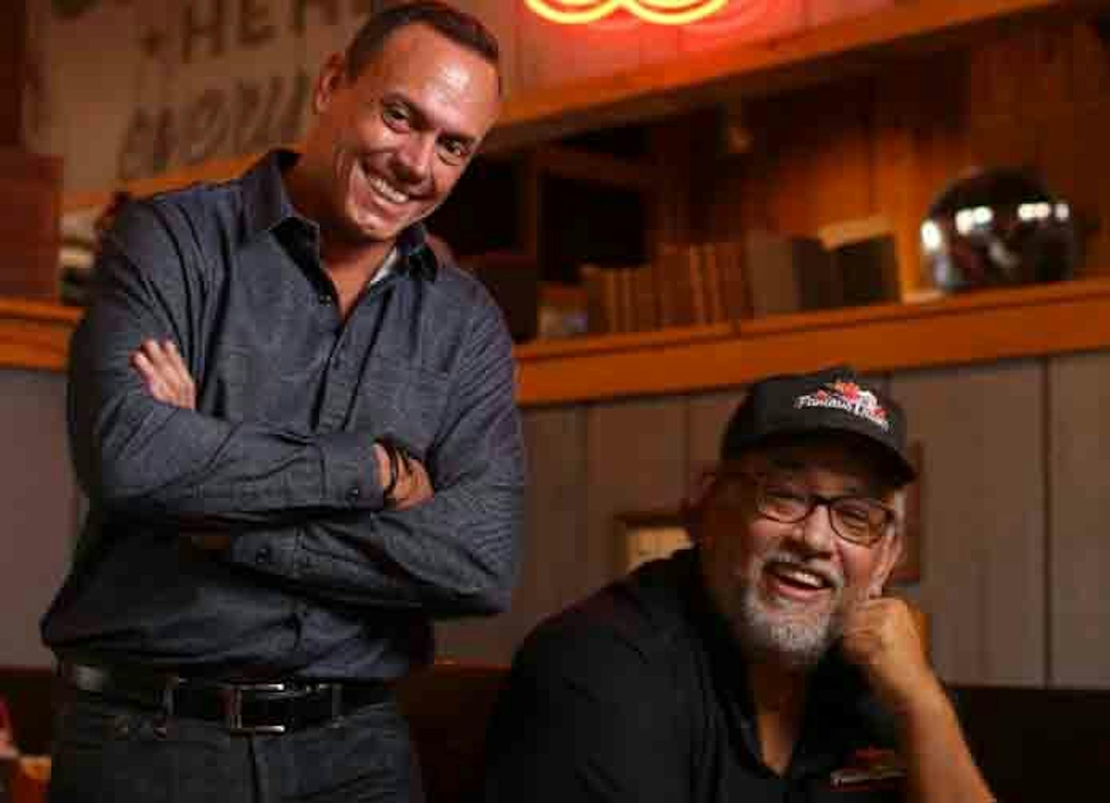 Famous Dave’s founder, Dave Anderson, seated, with Chief Marketing Officer Alfredo Martel in the refreshed Maple Grove location on Tuesday afternoon.