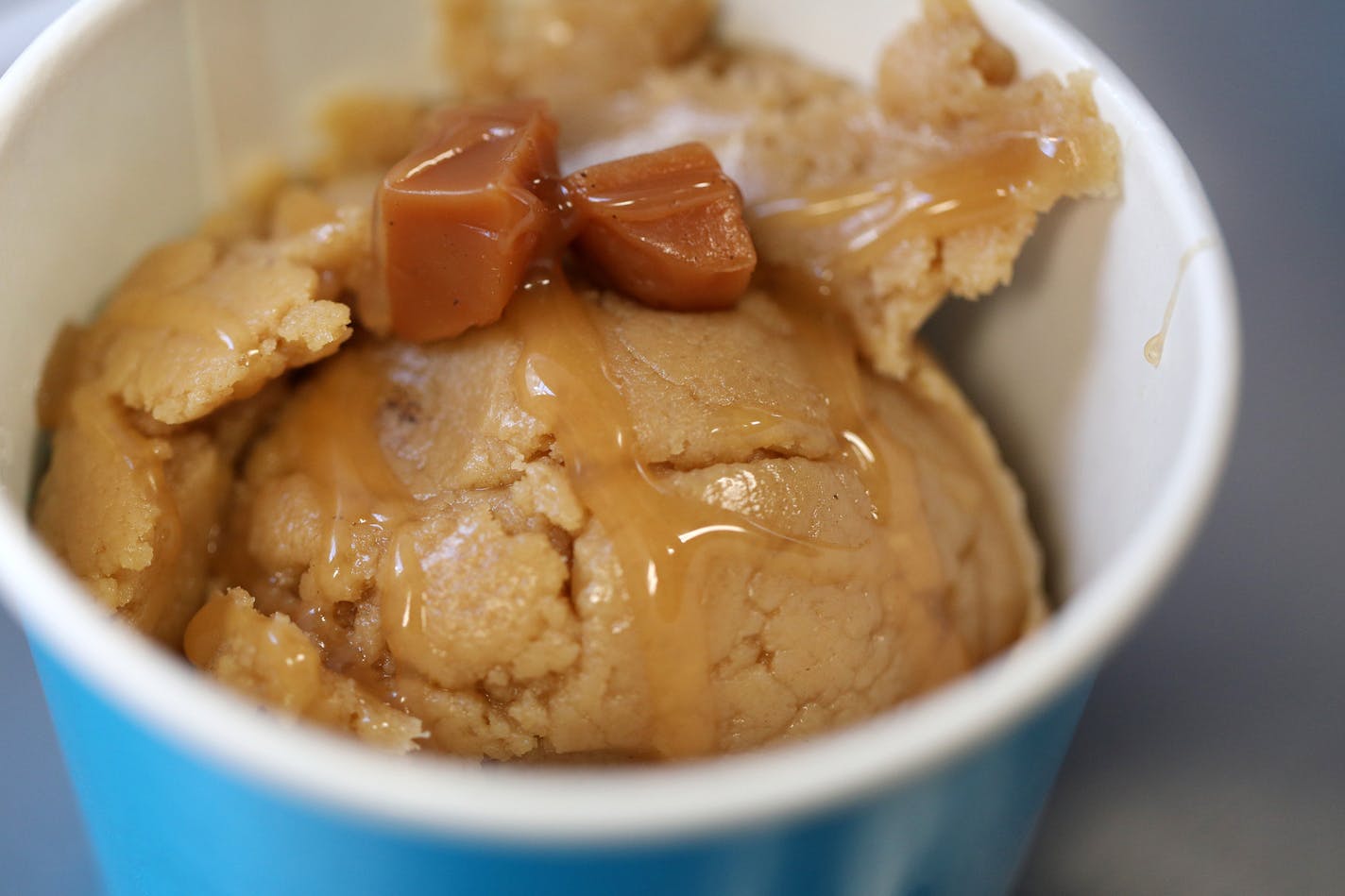 A scoop of salted caramel cookie dough sat ready for a patron on the Dough Dough food truck Wednesday in downtown Minneapolis. ] ANTHONY SOUFFLE &#xef; anthony.souffle@startribune.com Dough Dough food truck has become a craze, drawing long lines as it sat parked Wednesday, May 24, 2017 in downtown Minneapolis.