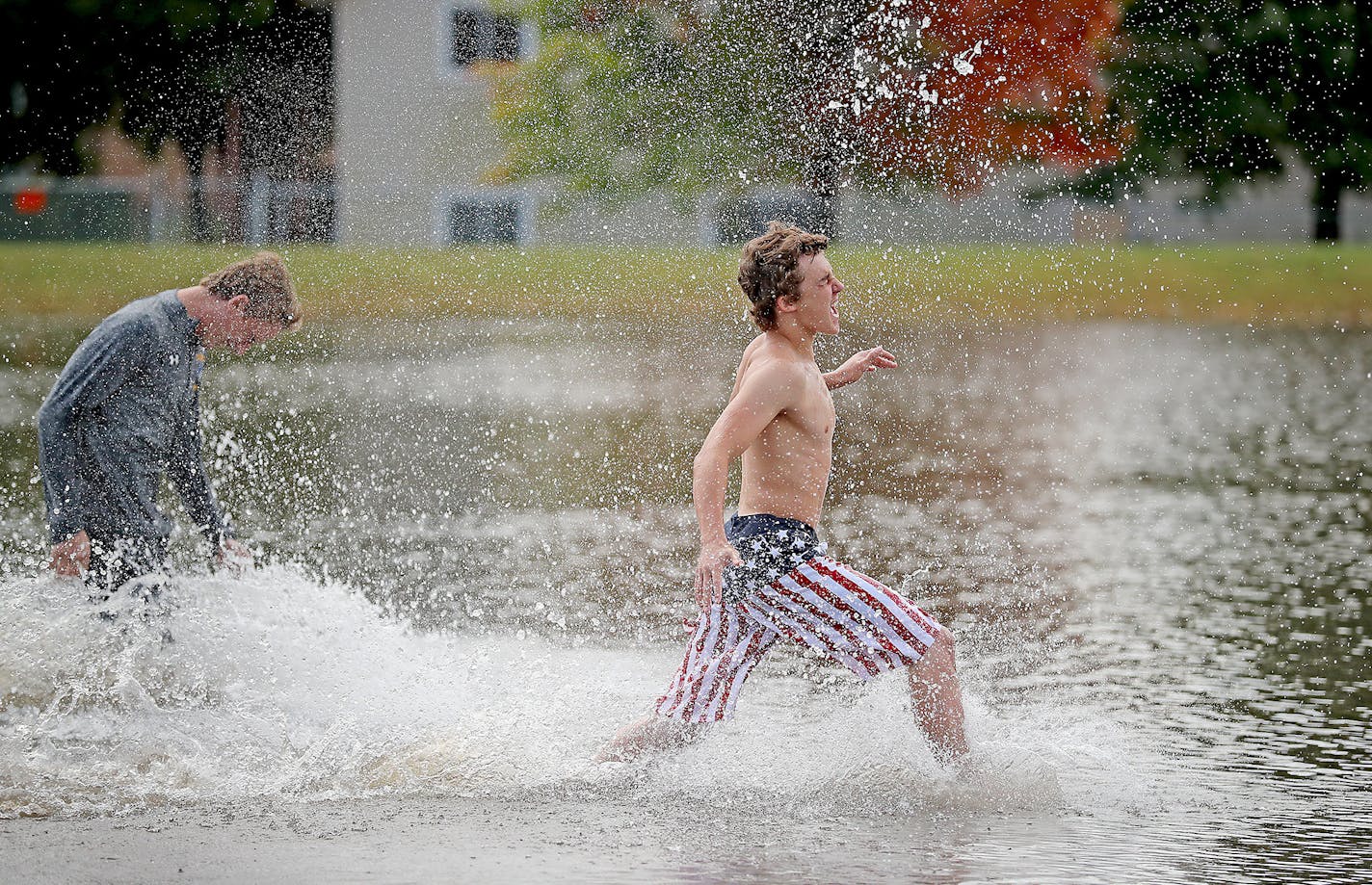 Dayton Deutsch led some of his football teammates to check out the flooding on the football field near the Waseca High School, Thursday, September 22, 2016 in Waseca, MN. ] (ELIZABETH FLORES/STAR TRIBUNE) ELIZABETH FLORES &#x2022; eflores@startribune.com