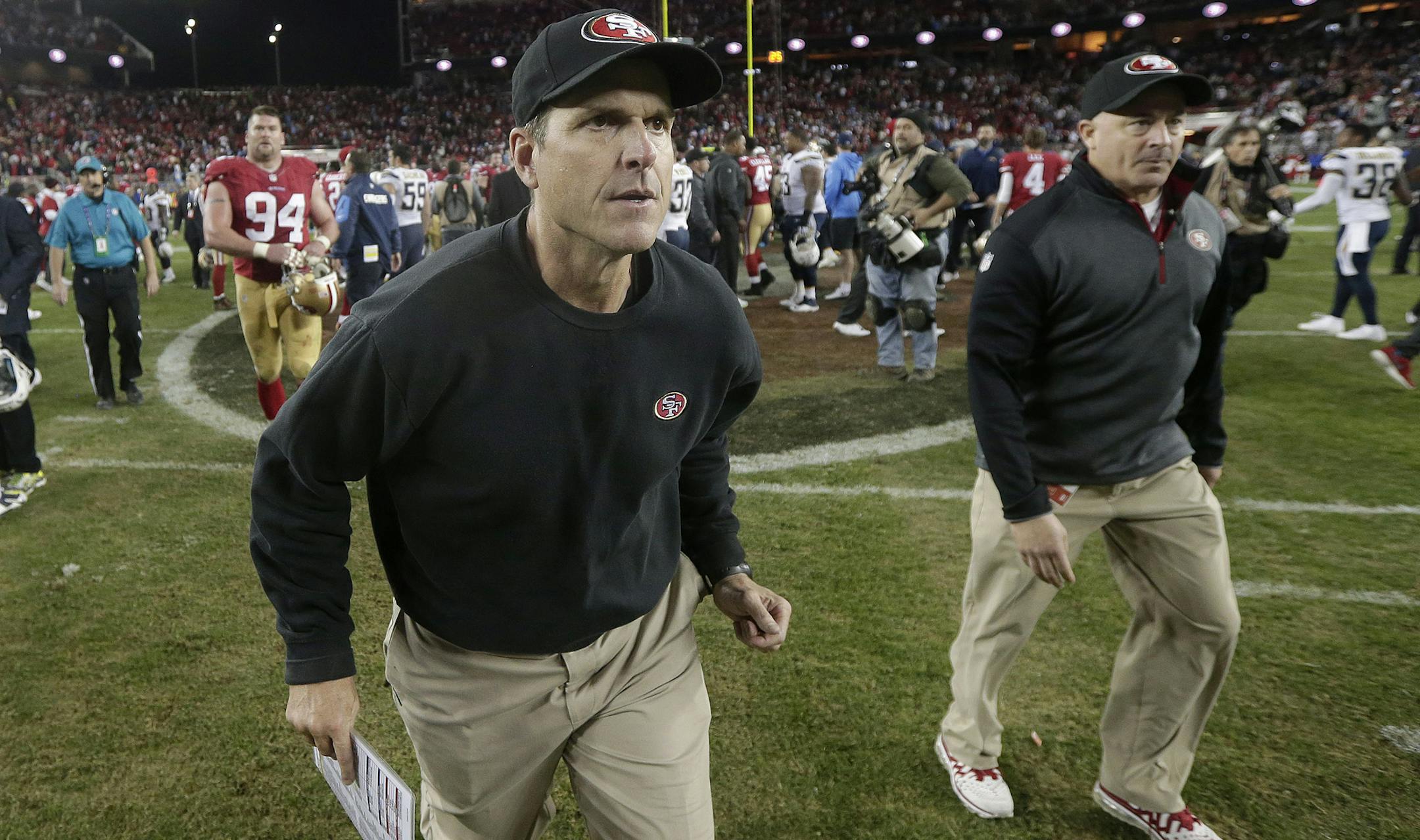 San Francisco 49ers head coach Jim Harbaugh walks off the field after the 49ers lost to the San Diego Chargers in an NFL football game in Santa Clara, Calif., Saturday, Dec. 20, 2014. (AP Photo/Marcio Jose Sanchez) ORG XMIT: FXN