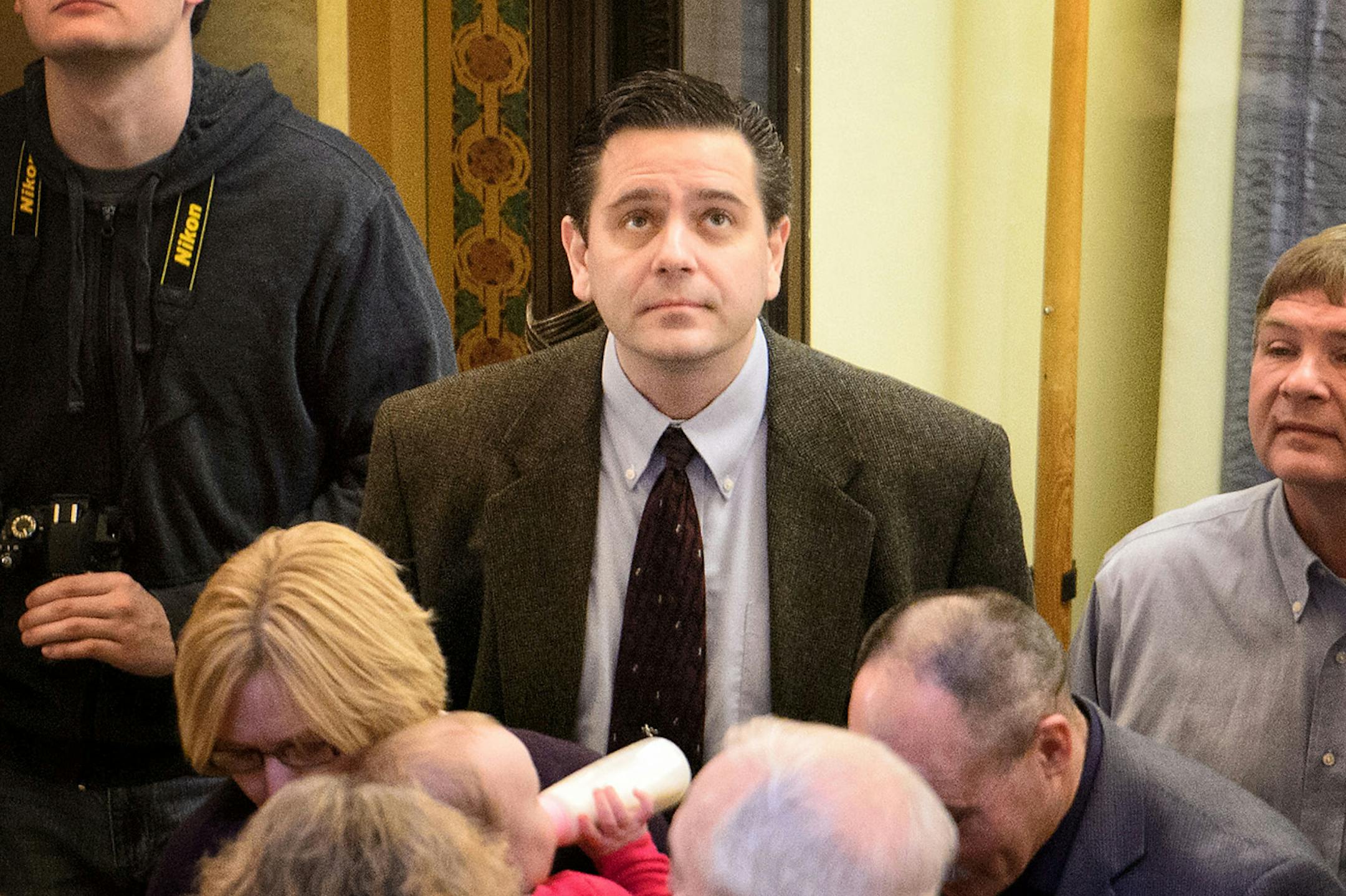 State Sen. Sean R. Nienow, R-Cambridge, stood toward the back of the Rotunda before the rally.  He and his wife have been sued and are accused of failing to make payments for the past 3½ years on a loan they took out from the Small Business Administration.