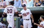 The Minnesota Twins Eddie Rosario gets a hand from manager Paul Molitor after hitting a grand slam against the Chicago White Sox during the third inni