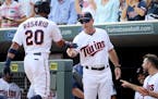 The Minnesota Twins Eddie Rosario gets a hand from manager Paul Molitor after hitting a grand slam against the Chicago White Sox during the third inni