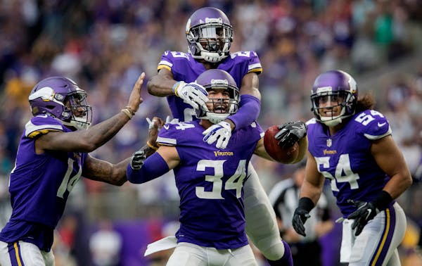 Andrew Sendejo celebrated with teammates after an interception against Tampa Bay.