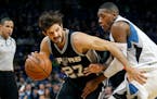 San Antonio Spurs guard Nicolas Laprovittola (27) tries to work arouind Minnesota Timberwolves guard Kris Dunn (3) in the second quarter of an NBA bas