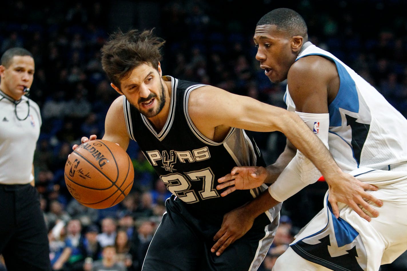 San Antonio Spurs guard Nicolas Laprovittola (27) tries to work arouind Minnesota Timberwolves guard Kris Dunn (3) in the second quarter of an NBA basketball game, Tuesday, Dec. 6, 2016, in Minneapolis. (AP Photo/Bruce Kluckhohn)