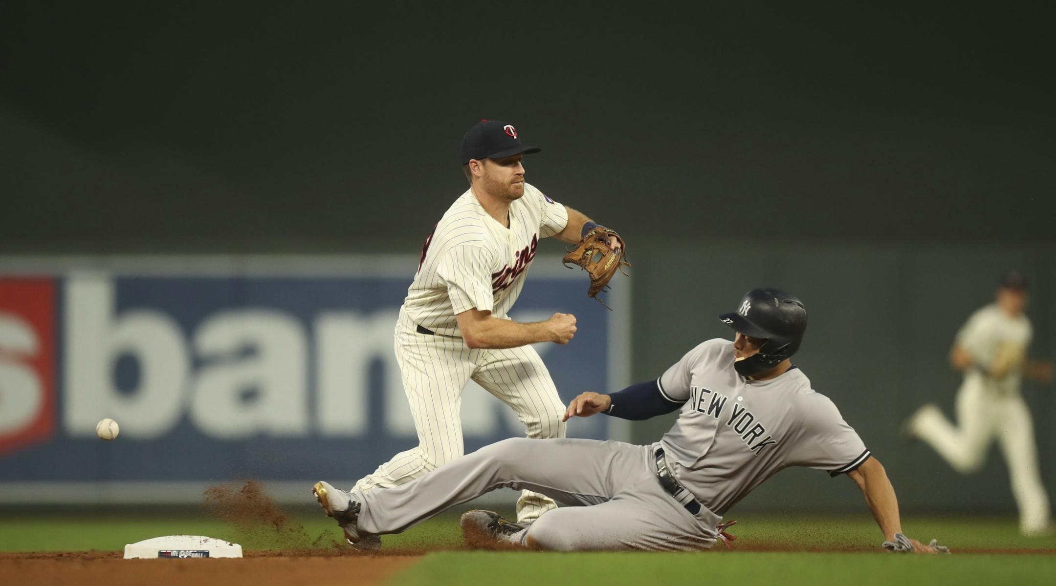 Minnesota Twins second baseman Logan Forsythe lost control of the ball after forcing out New York Yankees left fielder Giancarlo Stanton in the second inning.