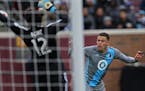 Goalie Brian Rowe(12) of the Galaxy blocks a shot by Christian Ramirez(21).] soccer game action, Loons host Los Angeles at TCF Stadium in Minneapolis.