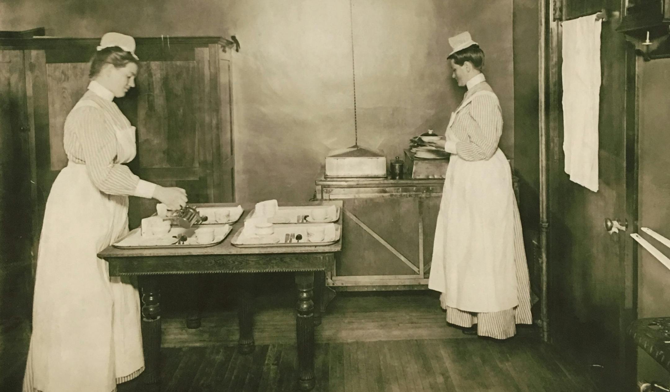 Nurses Elizabeth Gearson, left, and Beda Danielson prepared food trays in the Swedish Hospital's diet kitchen, 1902.