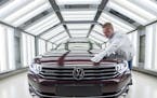 A worker checks a Passat Variant car during a press tour at the plant of the German manufacturer Volkswagen Sachsen in Zwickau, Germany.