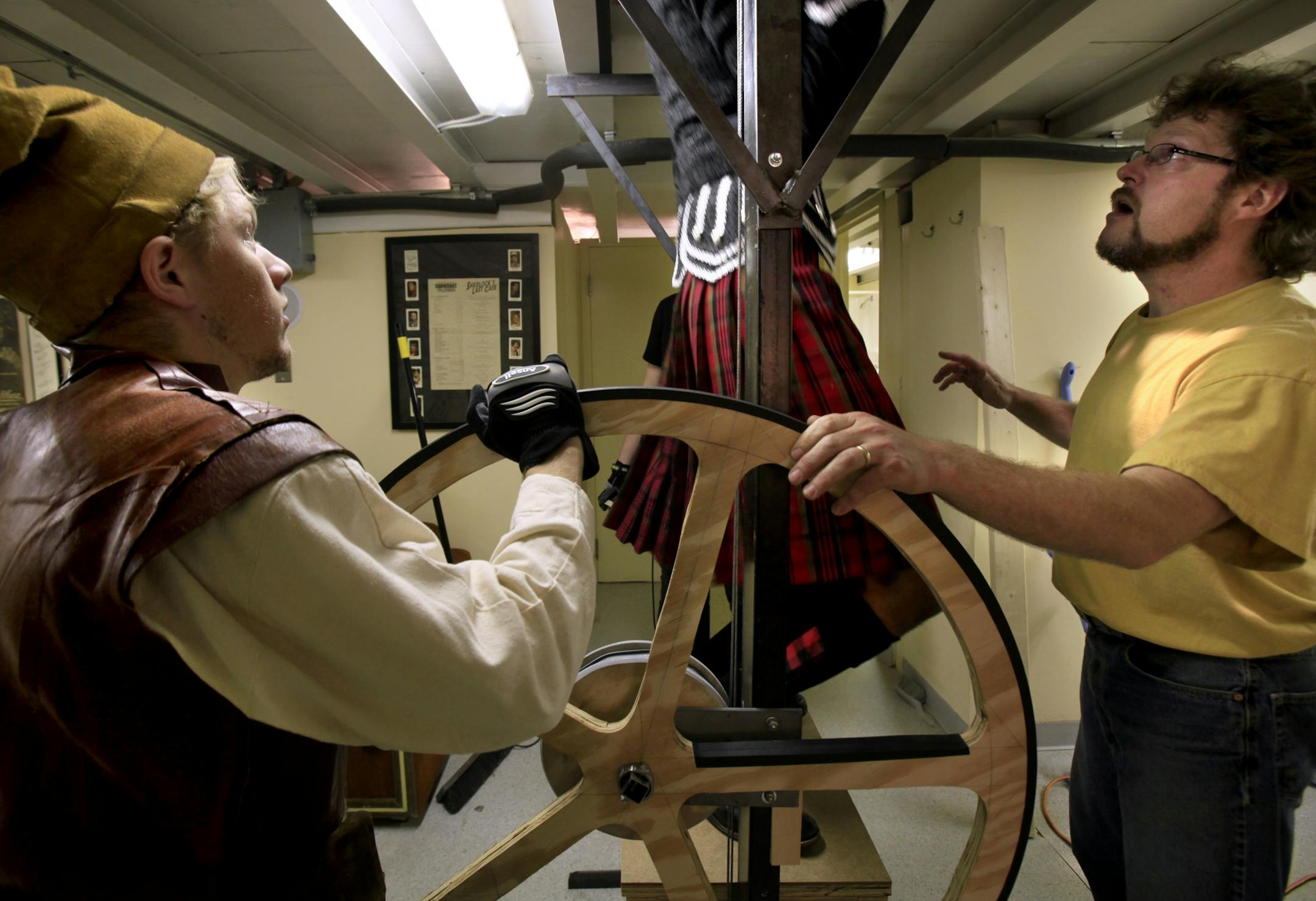 Actor Evav Adams (left) who plays M'Swill and technical director Roger Rosvold (right) check the trap floor as actor Ryan Colbert who plays Lord Ruthven in "The Vampire". The play will take place on the Minnesota Centennial Showboat at Harriet Island in St. Paul, MN . June 8, 2012.