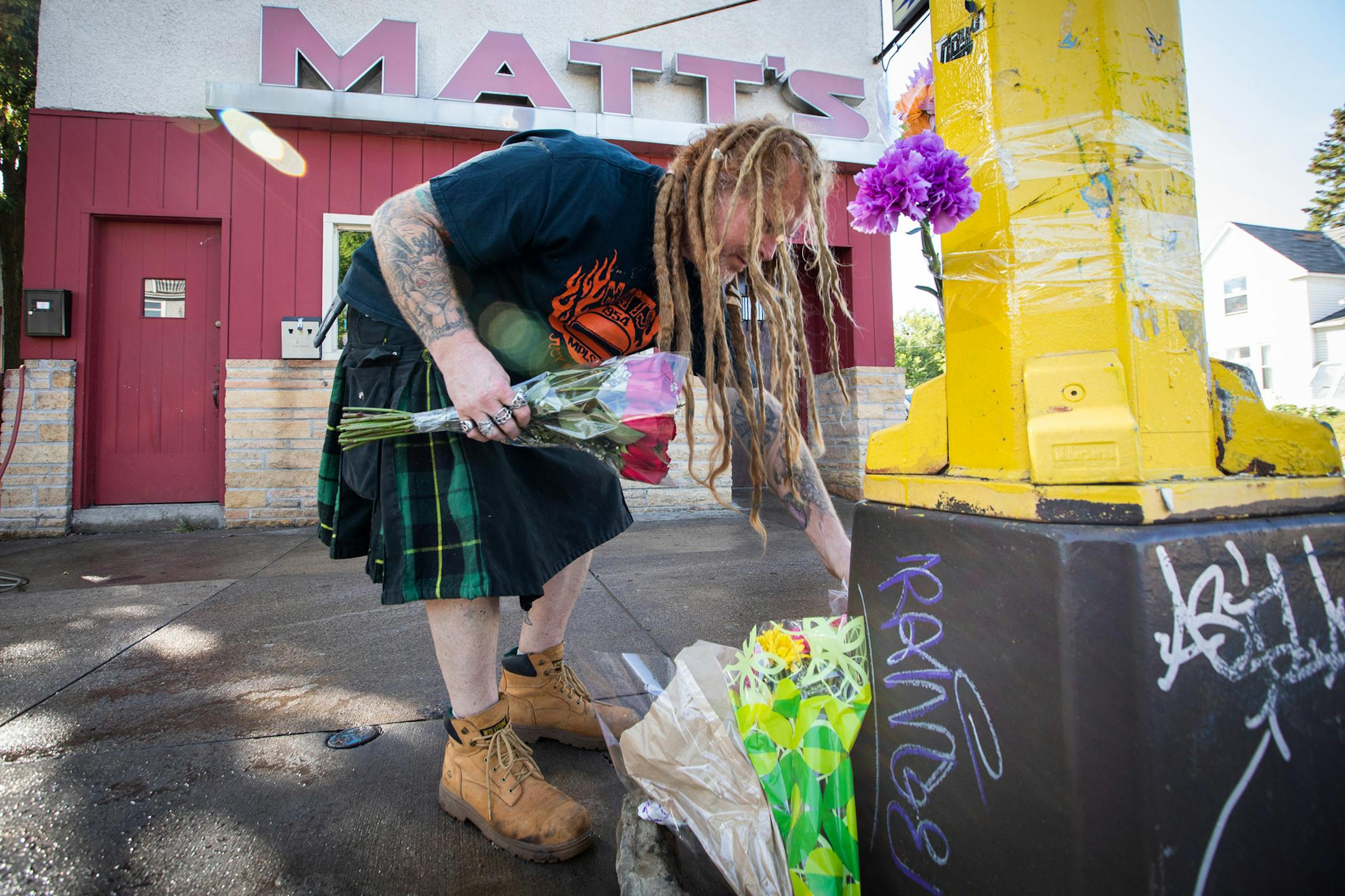 Matt's Bar general manager Paul Rees lays back down the flowers of a growing memorial after power washing the sidewalk outside of Matt's Bar. ] LEILA NAVIDI ï leila.navidi@startribune.com BACKGROUND INFORMATION: *Paul Rees (cq)*
A memorial for the victims is seen outside of Matt's Bar in Minneapolis on Sunday, September 23, 2018. A teenager speeding from state troopers in a stolen SUV hit another vehicle and killed three people early Sunday at a south Minneapolis intersection, where the wreckage