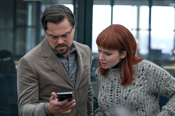 This image released by Netflix shows DiCaprio as Dr. Randall Mindy and Jennifer Lawrence as Kate Dibiasky in “Don’t Look Up.” 