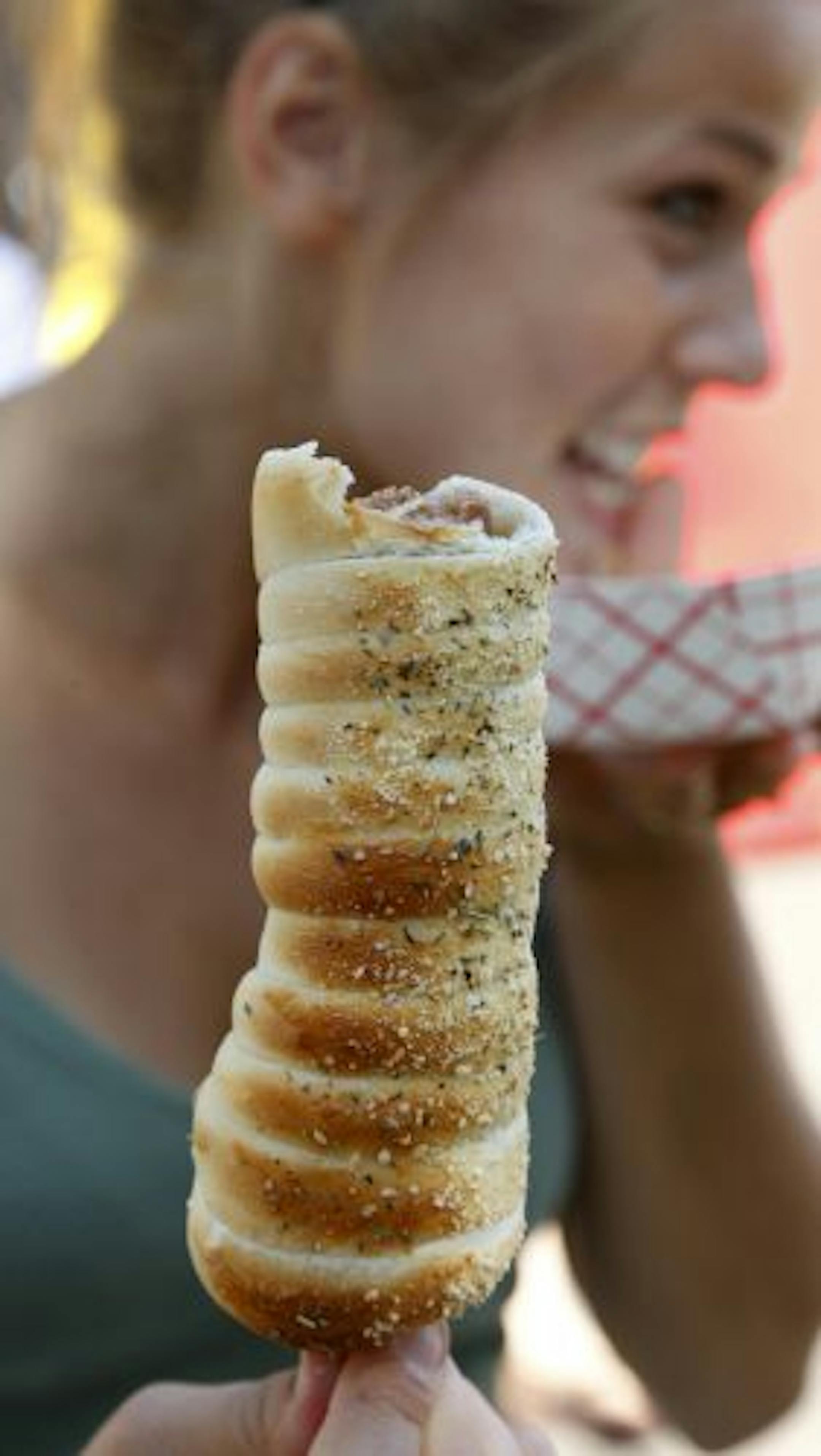 Tess Thompson of Plymouth enjoys a Twisted Sister sausage in a bread-stick crust.