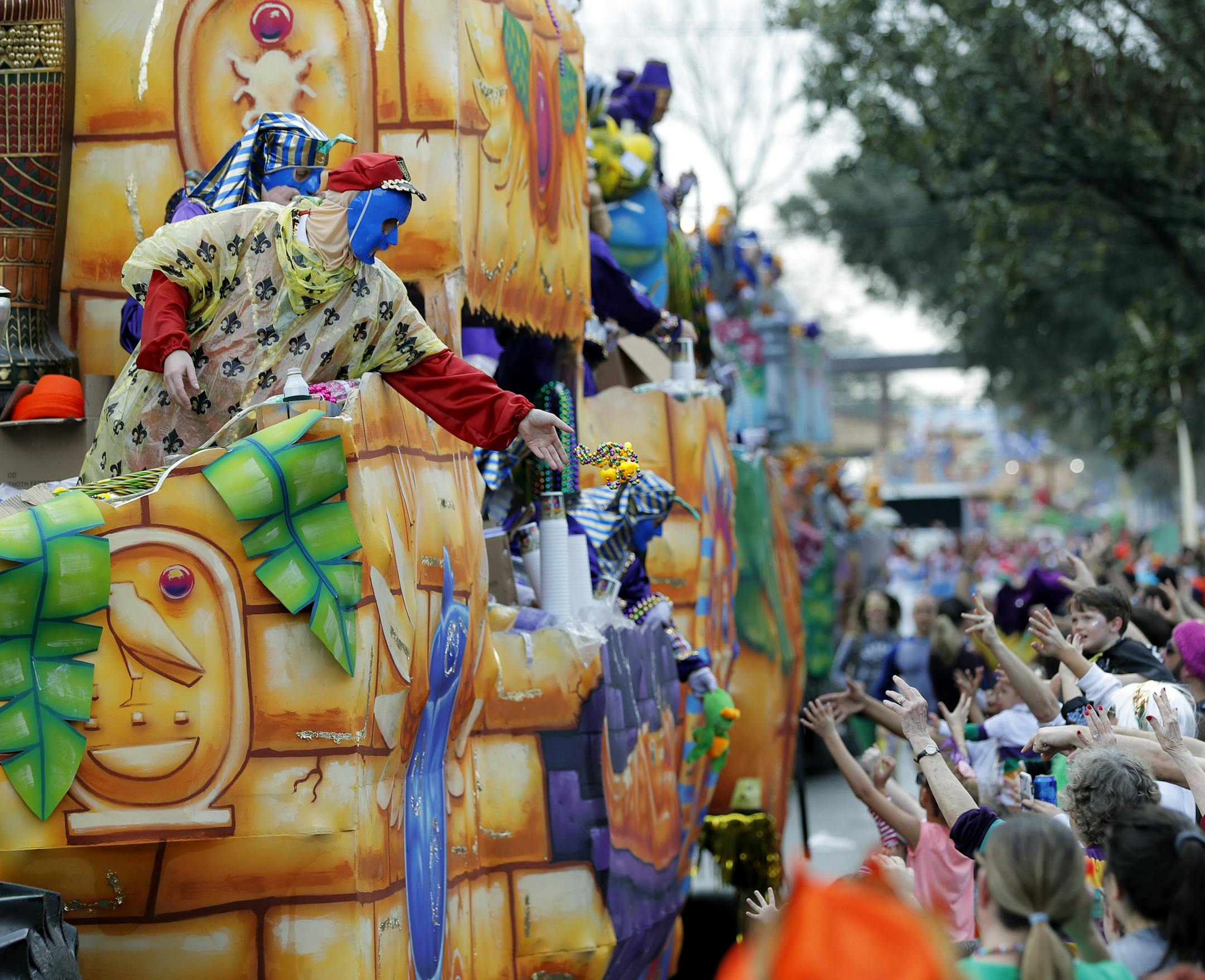 FILE - In this Feb. 11, 2018, file photo, float riders toss beads and trinkets during the Krewe of Thoth Mardi Gras parade in New Orleans. There won't be any parades on Mardi Gras or during the weeks leading up to it because they just can't fit within restrictions to slow the spread of the coronavirus pandemic, a city spokesman said Tuesday, Nov. 17, 2020. The 250-person cap on outdoor crowds is "a hard number. You can't have traditional parades with that small a group," city spokesman Beau Tidw
