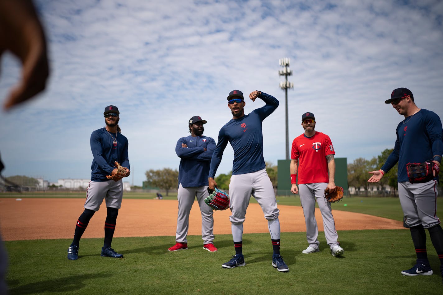 Outfielder Byron Buxton, center, reacted to seeing teammate Miguel Sano arrive on the field for warm ups at Hammond Stadium in Fort Myers, Florida Monday, March 14, 2022. After some late night roster moves, the Twins full squad reported to Spring Training for Monday's workout. ] JEFF WHEELER • Jeff.Wheeler@startribune.com