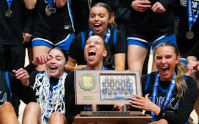 Minnetonka senior guard Tori McKinney screams in joy while holding the Class 4A championship trophy Saturday after the Skippers beat Hopkins 64-56 for