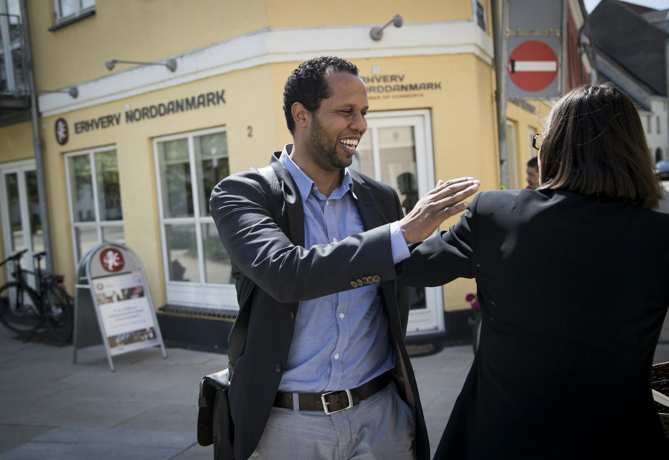 CREATING CONNECTIONS: Nuuradiin Hussein, who greeted a woman he knows in Aalborg, has spearheaded a partnership among the city, police and mosques. &#x201c;You don&#x2019;t have any excuses not to get a good life,&#x201d; he said.