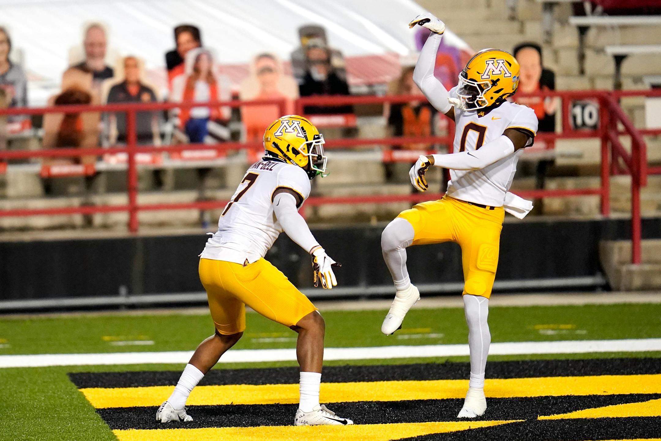 Minnesota wide receiver Rashod Bateman (0) celebrates after wide receiver Chris Autman-Bell (7) caught a touchdown pass during the second half of an NCAA college football game against Maryland, Friday, Oct. 30, 2020, in College Park, Md. (AP Photo/Julio Cortez)