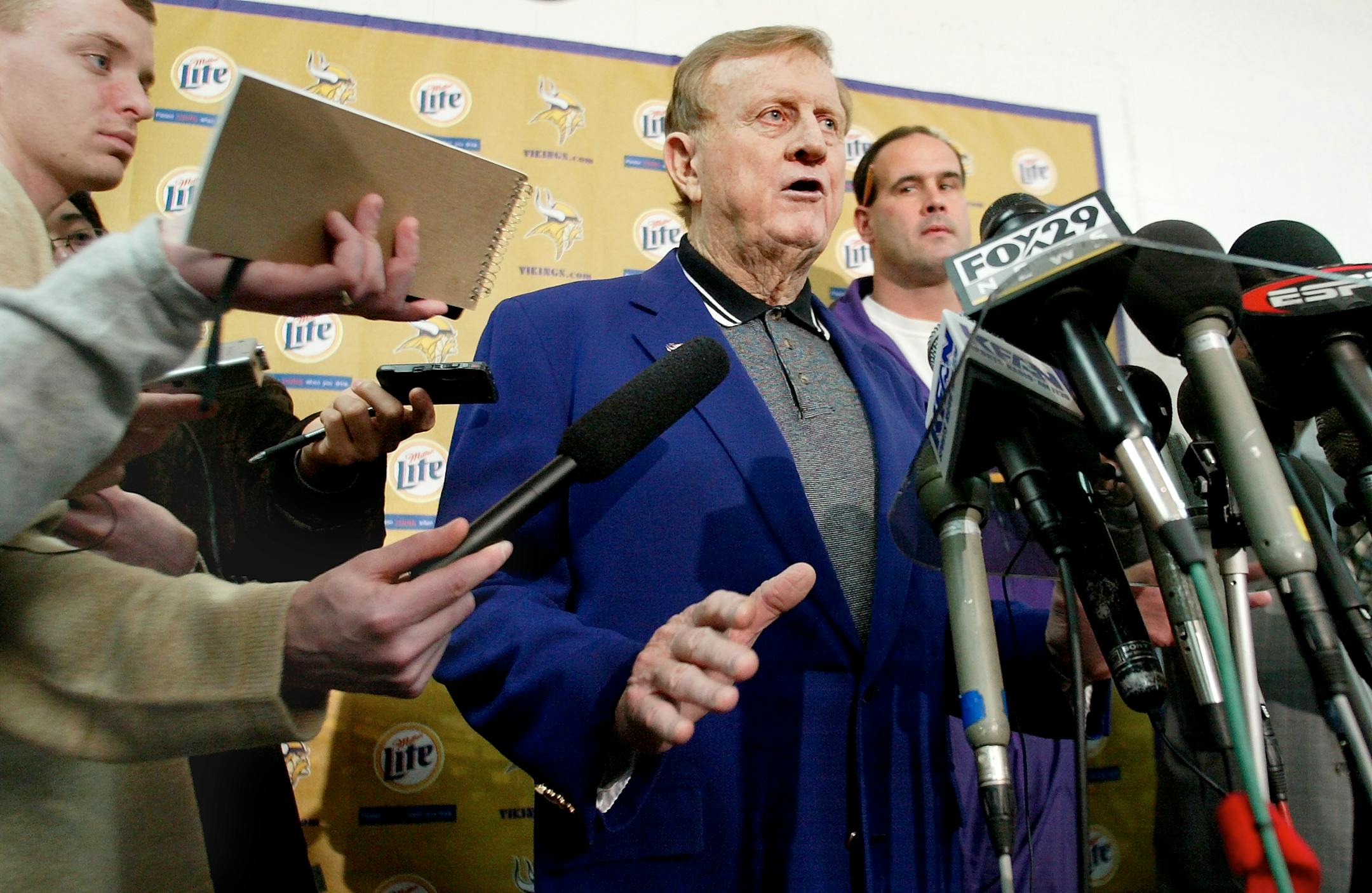 Vking owner Red McCombs annouces the elevation of Mike Tice (behind McCombs} to interim head coach of the Vikings during a press conference at Winter Park.