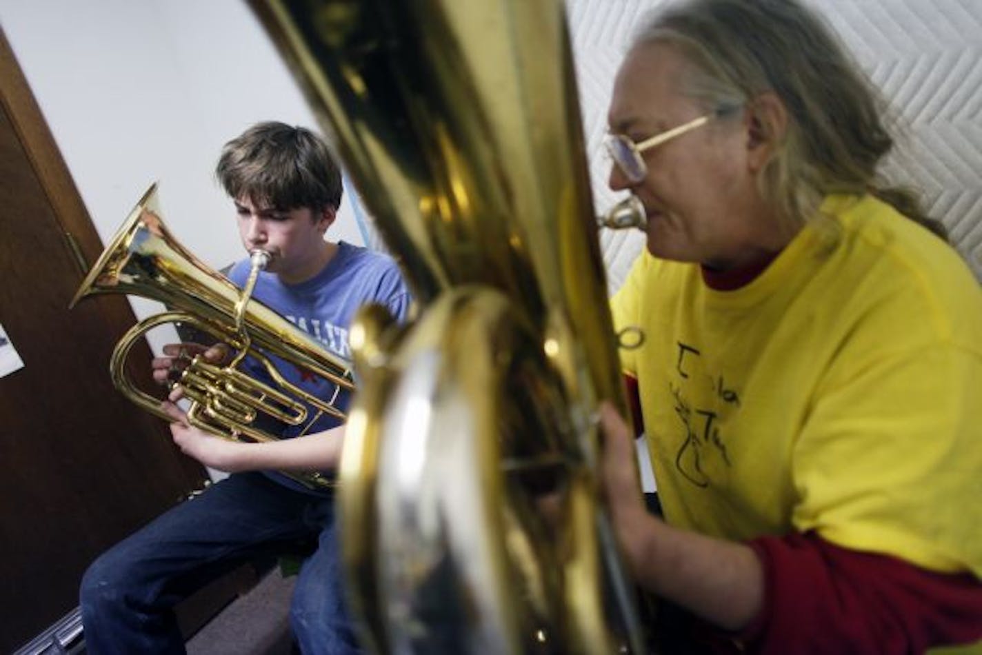 Kip Hathaway of Capitol Hill Magnet School got a tuba lesson from Scott Anderson, a brass instrument teacher at Cadenza Music. "Music is one of the defining terms of civilization," said Hathaway. Cadenza owner Monnig has advocated for school programs and kept parents and kids up on St. Paul's music news.