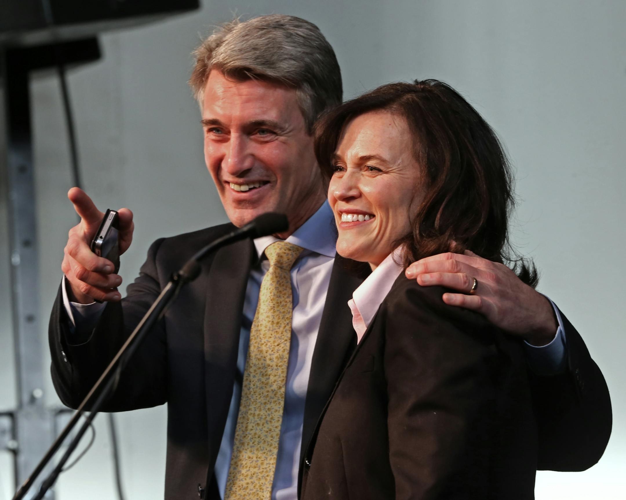 (left to right) Former Minneapolis Mayor R.T. Rybak and new mayor Betsy Hodges tstood on stage, after she took the oath during her first swearing in ceremony at the Thorp building in North Minneapolis on 1/2/14. Several hundred friends, family and supporters attended the ceremony. Hodges' formal swearing in (where she will give her inaugural speech) is Monday, Jan. 6. Under city charter, she is required to be sworn in on the first business day of January, which is Jan. 2.