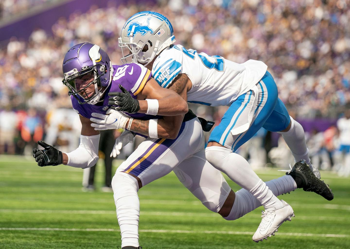 Detroit Lions cornerback Amani Oruwariye ,(24) was call for pass interference as he hits Minnesota Vikings wide receiver Justin Jefferson (18) in the second quarter in Minneapolis.,Minn. on Sunday September 25, 2022.