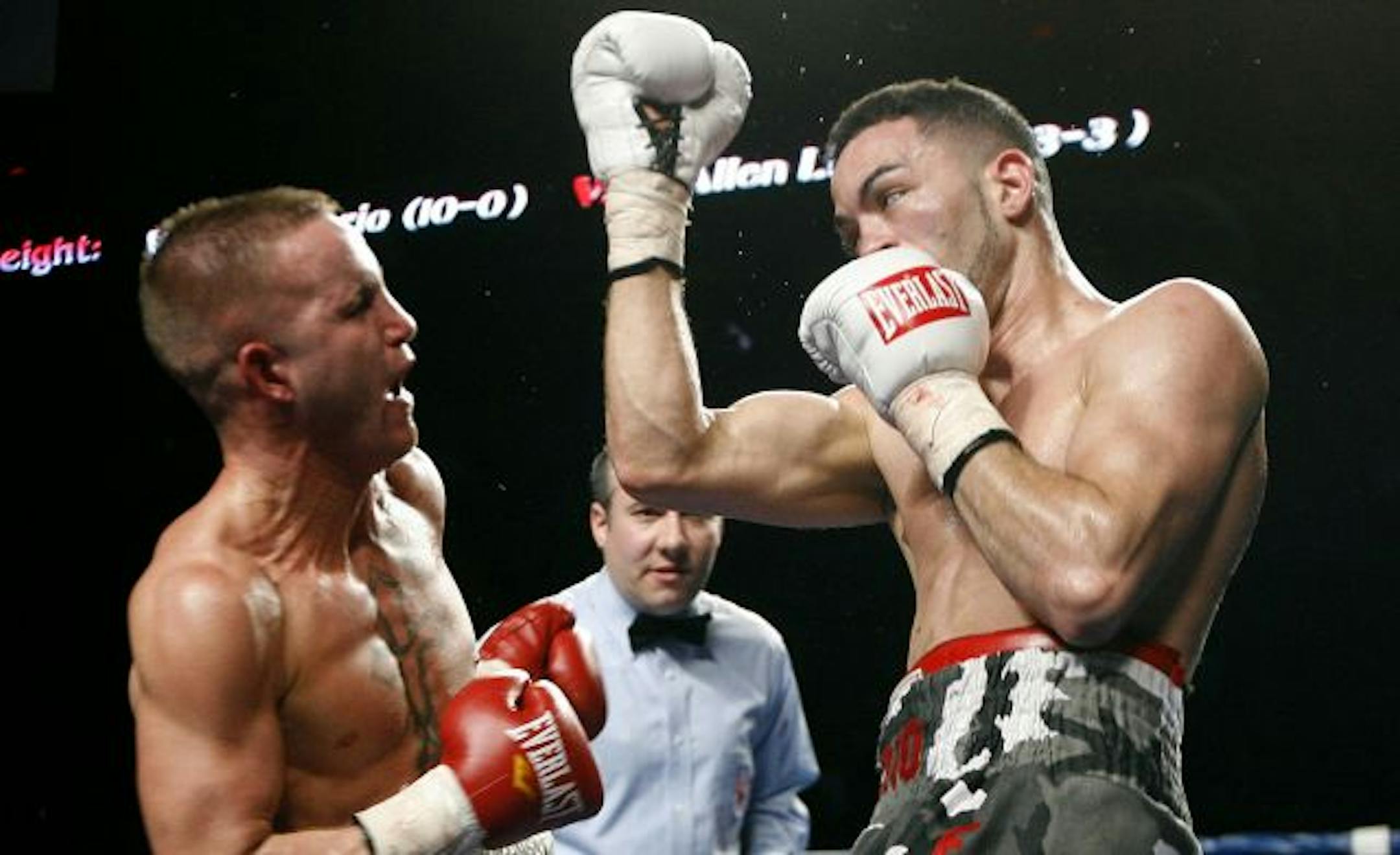 Super featherweight Wilton Hilario, right, delivers an underfuct to Allen Litzau Litzau in the 3rd round before a TKO of Litzau in the 4th to capture the IBA title during Fight Night at Target Center in Minneapolis.