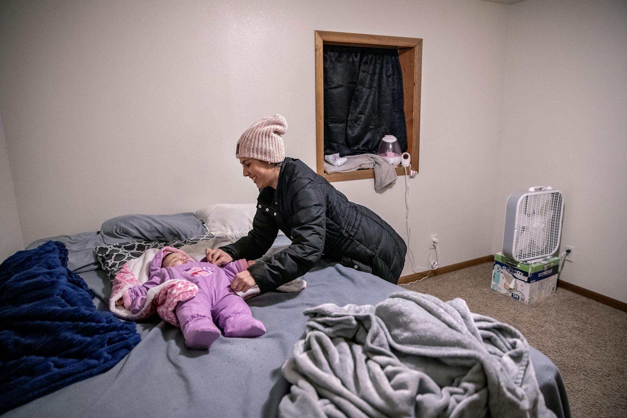 Gabriela Ferrao, spoke of the generostiy that has been showed to her from the people of Roseau as she put her 8-month-old baby daughter, Gia, to bed, Sunday, February 16, 2020 in Roseau, MN. Ferrao said that she was given everything from coats, hats to furniture from members of the community.