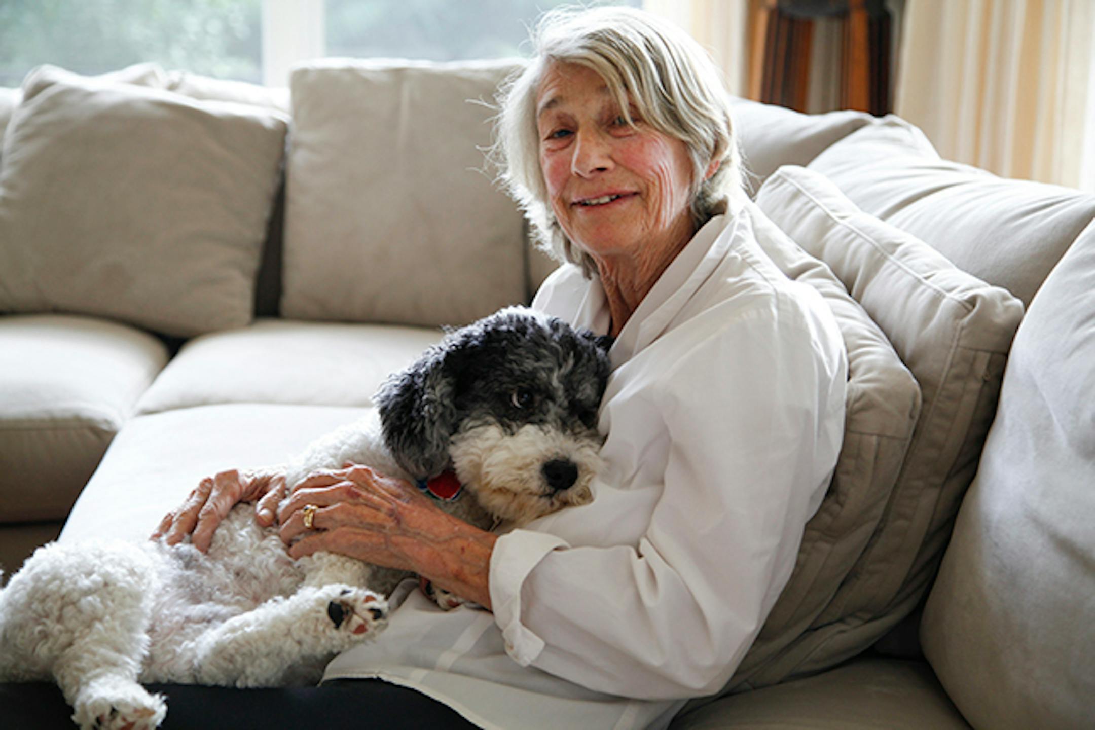 Mary Oliver, a best-selling poet, with Ricky, a Havanese who plays a part in her latest collection, "Dog Songs," at her home in Hobe Sound, Fla., Sept. 26, 2013. In "Dog Songs," Oliver finds inspiration in love, impermanence and canine companionship. (Angel Valentin/The New York Times)