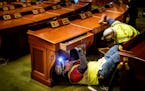 Crews removed desks in the House Chamber.