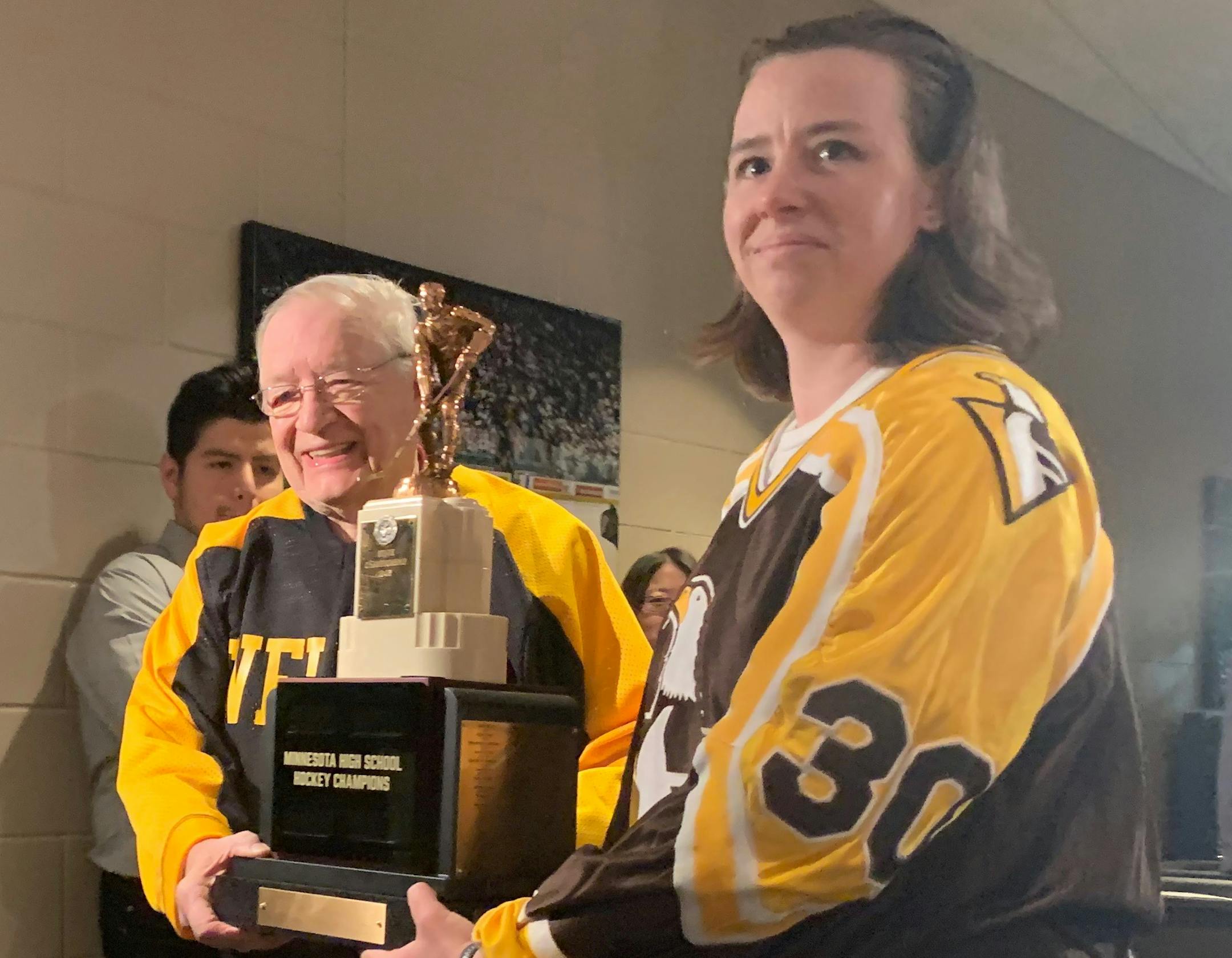 Edina hockey coaching great Willard Ikola and Jenny Jannett, who helped Apple Valley win the first girls' hockey state championship in 1995, held The Eveleth Trophy at a news conference Tuesday at Xcel Energy Center. Photo: Jack Warrick, Star Tribune