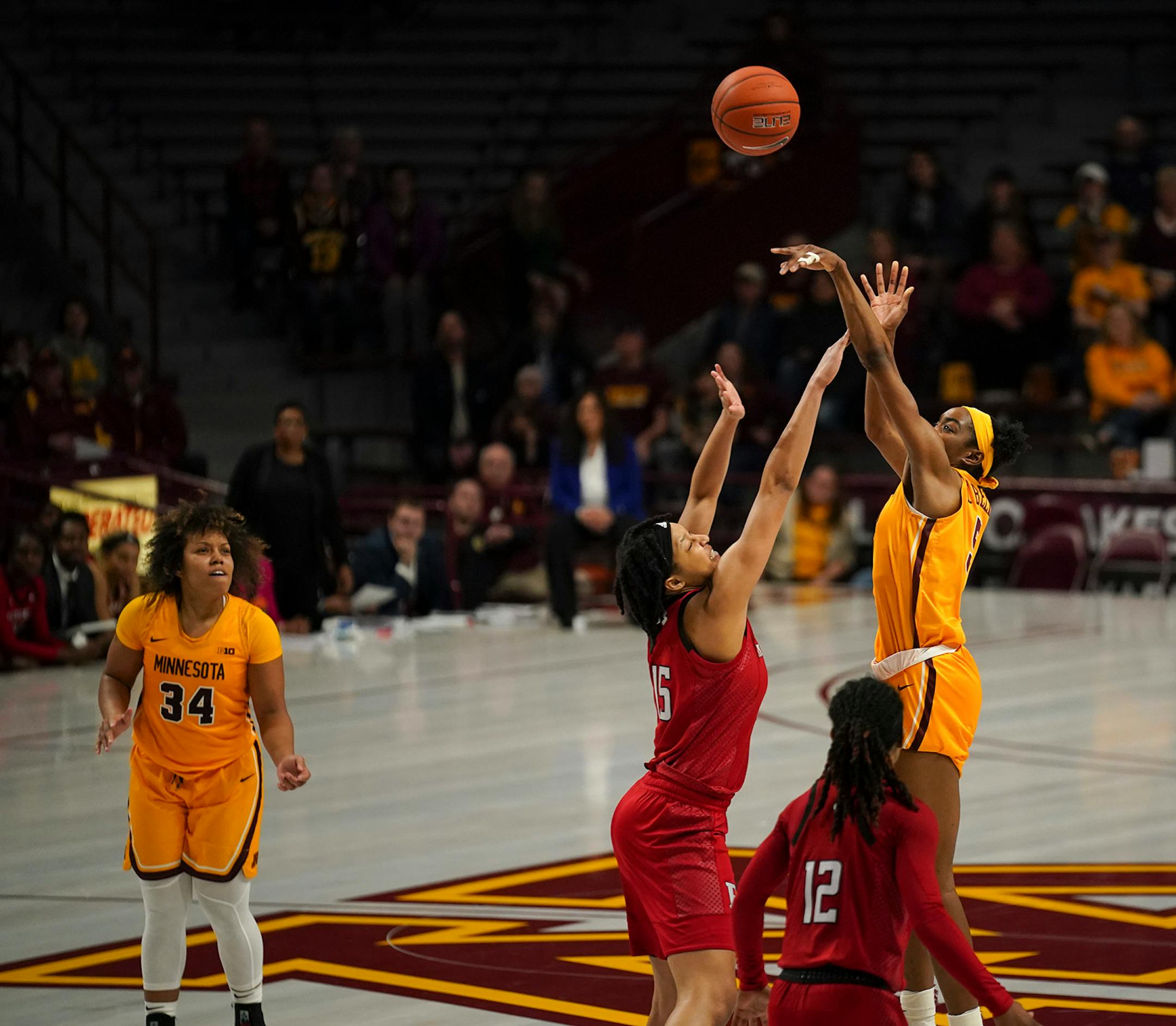 With Minnesota ahead 64-63, Gophers forward Taiye Bello (5) was fouled by Rutgers Scarlet Knights center Maori Davenport (15). She went on to sink all three of her free throws.