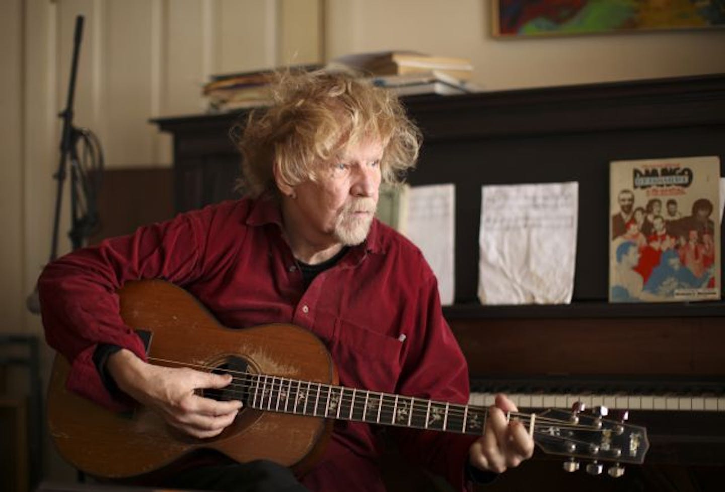 Willie Murphy strummed one of his guitars at home in Minneapolis Monday afternoon.