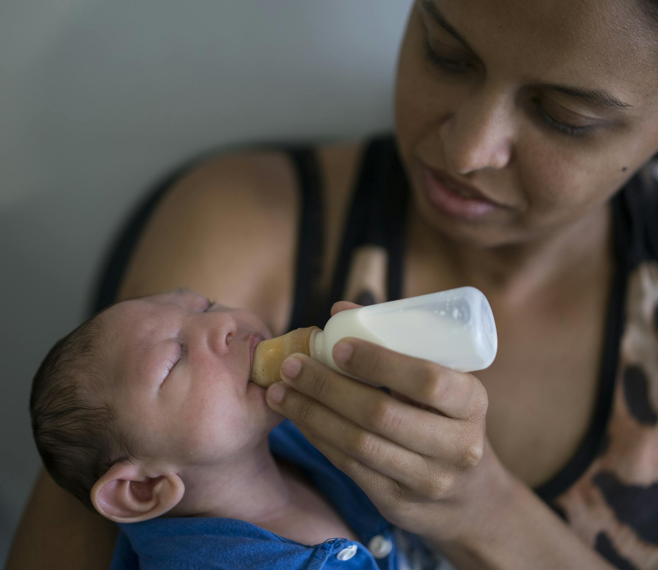 Daniele Ferreira dos Santos feeds her son Juan Pedro, who suffers from microcephaly, as they wait to be examined at the Altino Ventura Foundation, a treatment center that provides free health care, in Recife, Pernambuco state, Brazil, Thursday, Feb. 4, 2016. Brazil is in the midst of a Zika outbreak and authorities say they have also detected a spike in cases of microcephaly in newborn children, but the link between Zika and microcephaly is as yet unproven. (AP Photo/Felipe Dana)