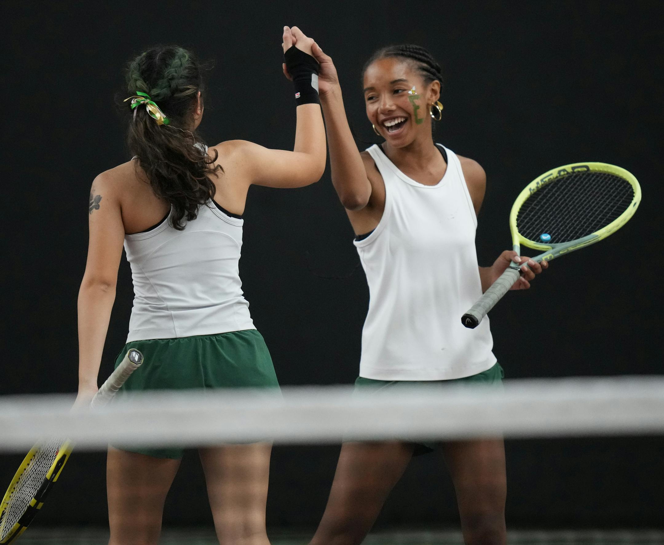 Lauryn Schenck and Zoya Hasan of Edina, l to r, celebrate a play at the Baseline Tennis Center in Minneapolis, Minnesota on Wednesday, Oct. 25, 2023.