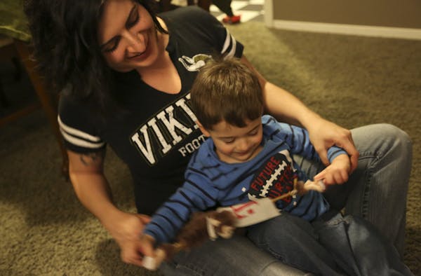 Jen Jamar played with a sling-shot monkey with her 2-year-old son, Levi, before bedtime at their home in Robbinsdale.