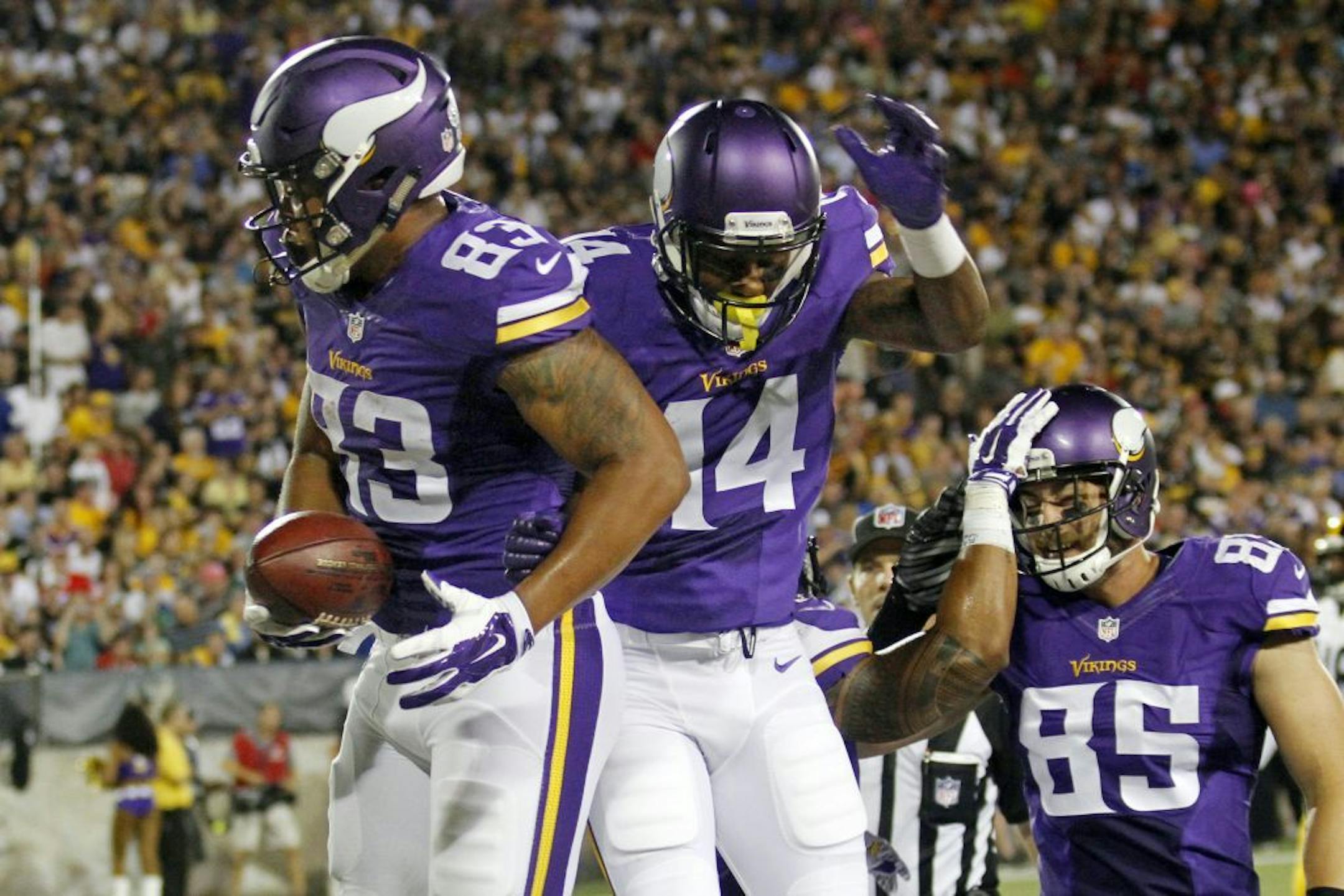 Minnesota Vikings tight end MyCole Pruitt, left celebrates with teammate Stefon Diggs, center, after scoring on a pass from quarterback quarterback Mike Kafka during the first half of an NFL preseason football game against the Pittsburgh Steelers in Canton, Ohio, Sunday, Aug. 9, 2015.
