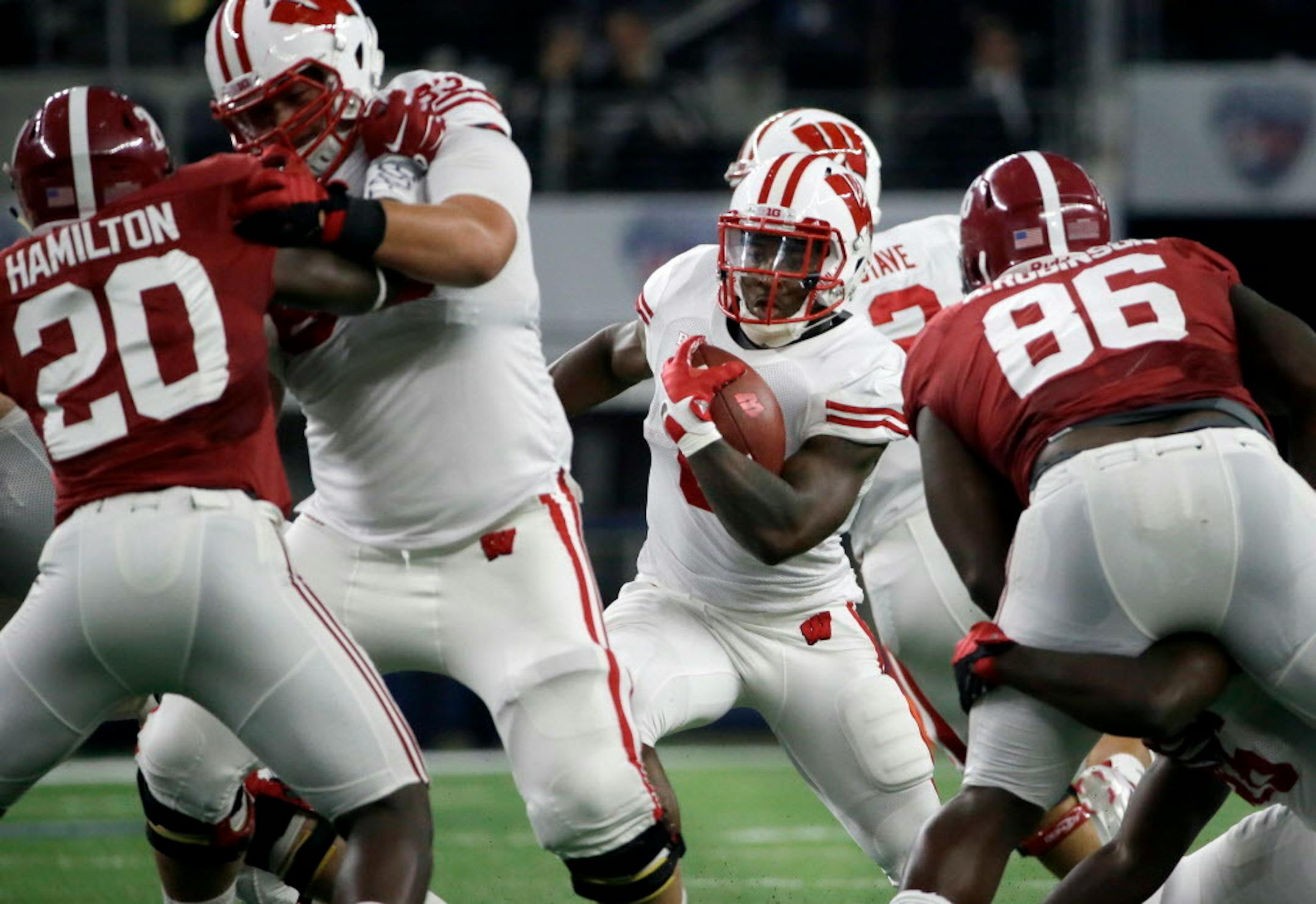Wisconsin running back Corey Clement looks for room as teammate offensive lineman Walker Williams blocks Alabama linebacker Shaun Hamilton (20) during the first half of an NCAA college football game Saturday, Sept. 5, 2015, in Arlington, Texas. Alabama won 35-17. (AP Photo/LM Otero)