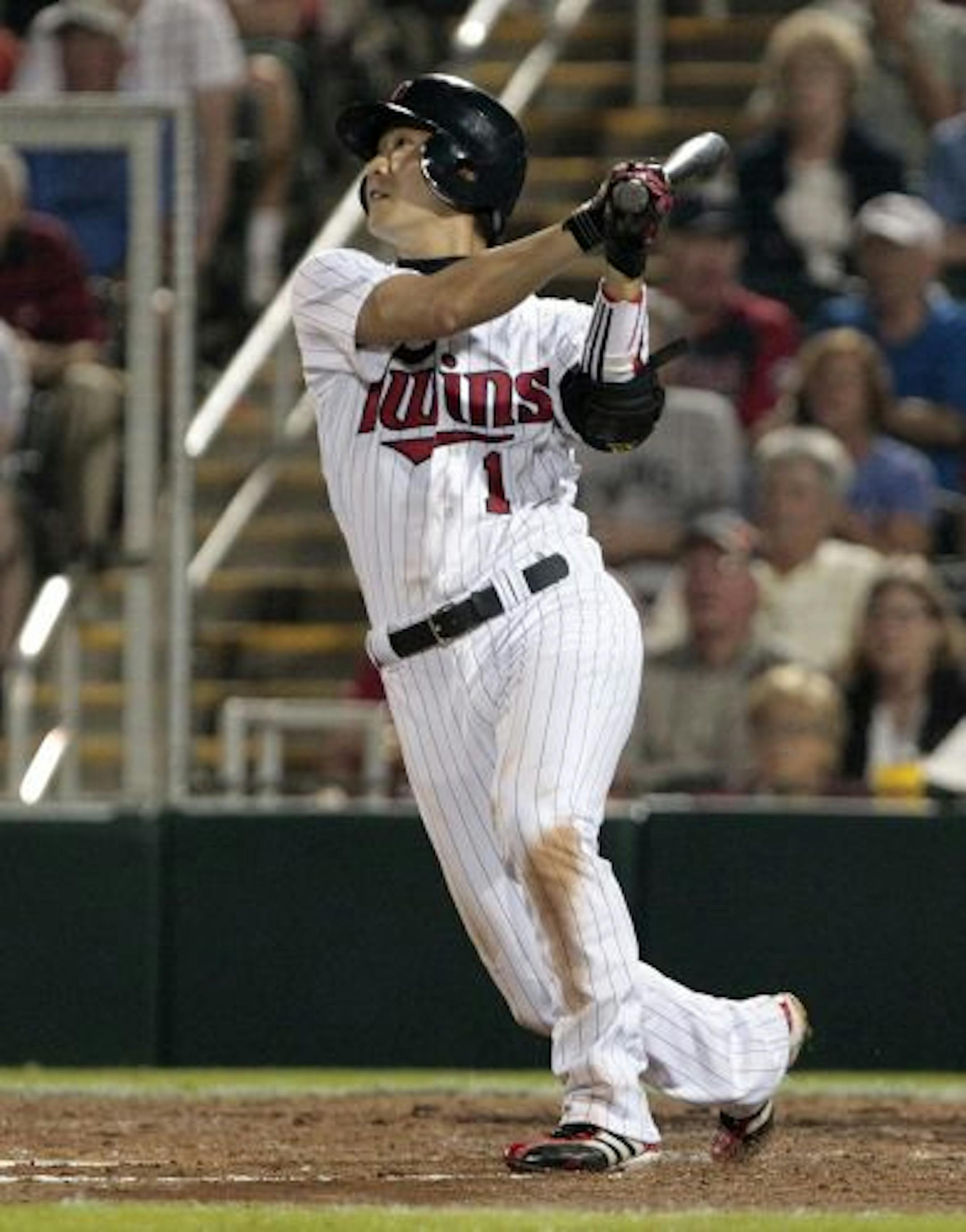 Minnesota Twins infielder Tsuyoshi Nishioka of Japan watches his single in the fifth inning off Boston Red Sox pitcher Hideki Okajima of Japan in their Grapefruit League spring training season opening baseball game at Hammond Stadium in Fort Myers, Fla., Sunday, Feb. 27, 2011.