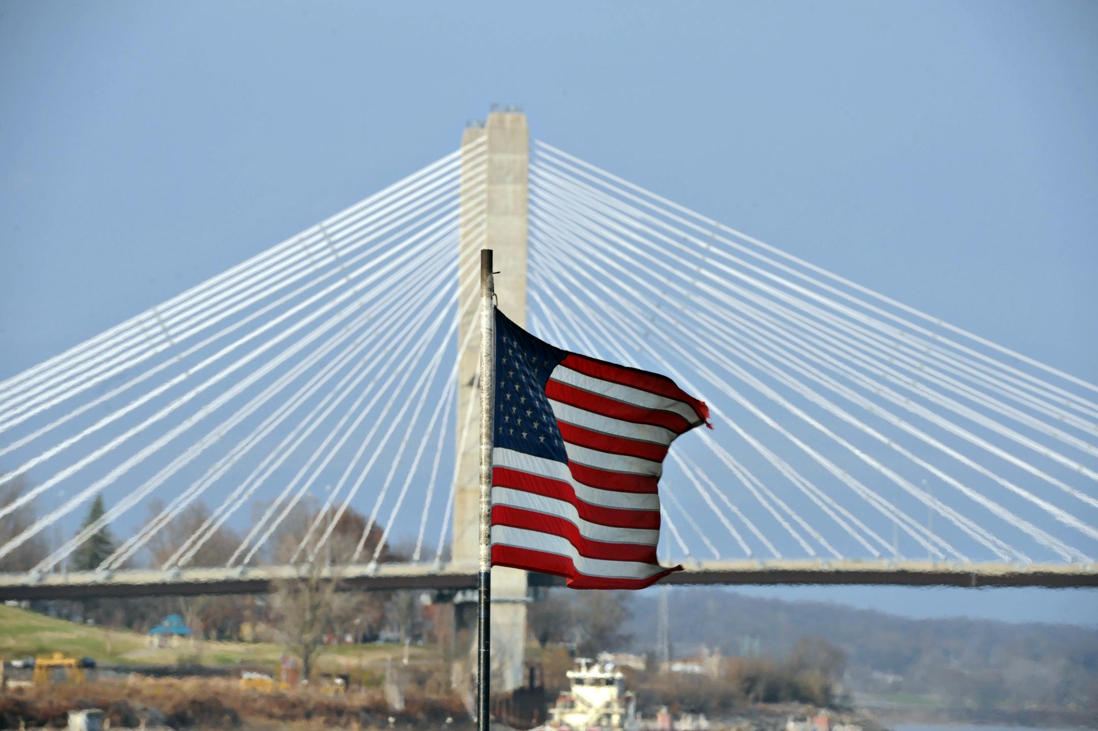 A U.S. flag flies on the Capt. Bill Stewart tow boat as it travels on the Mississippi River near Cape Girardeau, Missouri, U.S., on Friday, Dec. 7, 2012. Barges carrying grain, soybeans, coal, oil and other commodities on the Mississippi River have started to reduce their loads to navigate waters shrunk by the worst drought in 50 years. Photographer: Daniel Acker/Bloomberg
