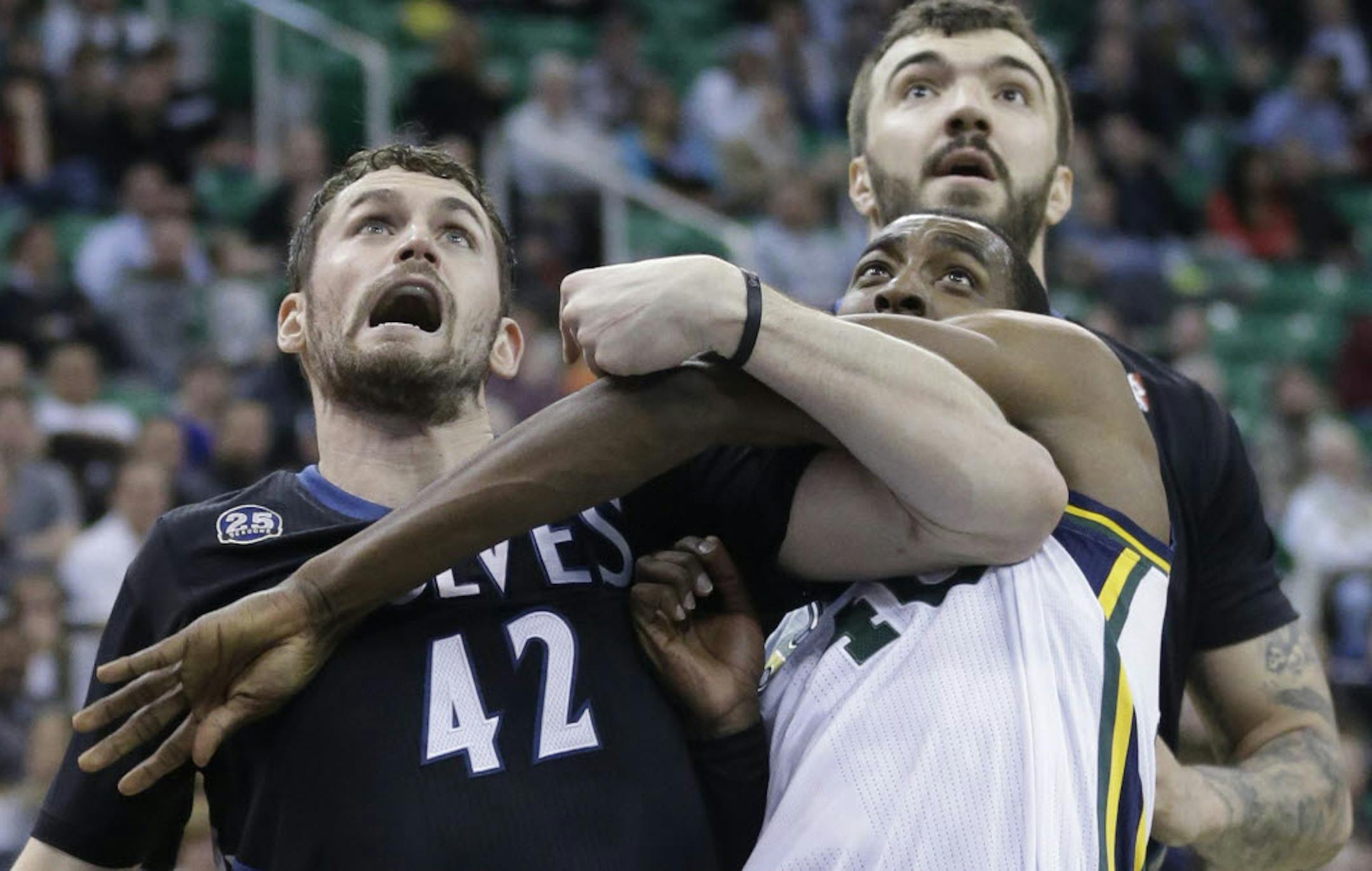 Utah's Jeremy Evans (40) battled under the boards with Minnesota's Kevin Love (42) and Nikola Pekovic.