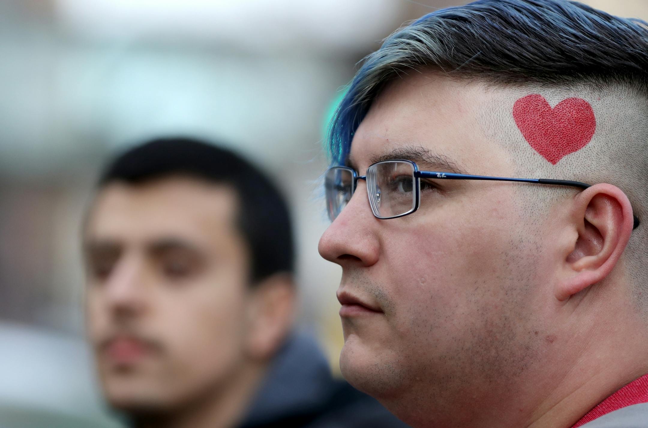 Mark Redacted of Minneapolis drew a heart on his head for The Caravan of Love: A Walk of Love for Immigrants and Refugees,