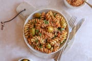 The delicious pasta dish known as Pasta Pangrattato is made from everyday pantry ingredients and here is adorned with olives, herbs and breadcrumbs.
