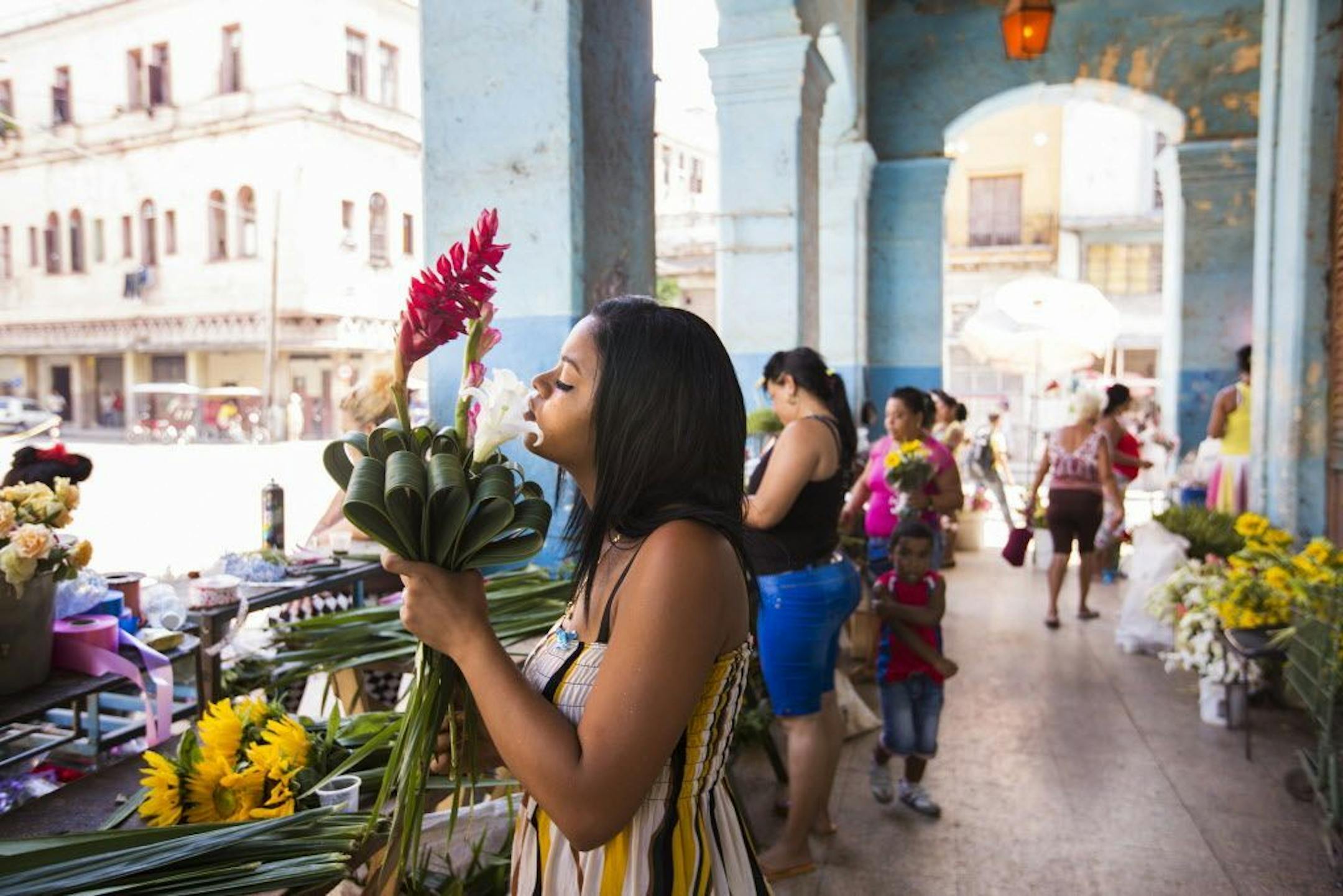 Marilenis Cobas Pompa arranges flower bouquets in an open air flower market in Old Havana, Cuba on Saturday, May 16, 2015.
