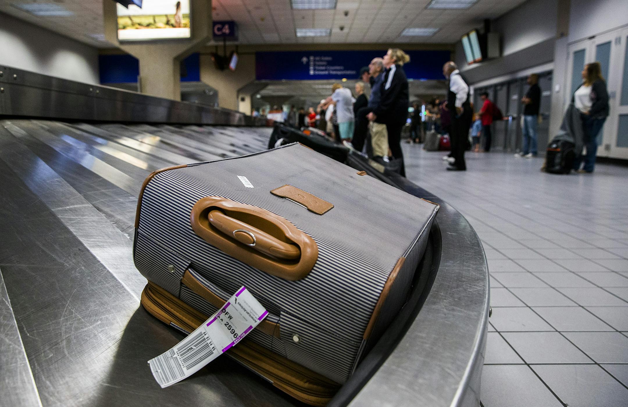Luggage circles a baggage claim at Gate C on March 10, 2017, at DFW International Airport in Dallas, Texas.