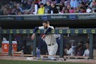 Twins Joe Mauer stood in the dugout during a game at Target Field. Next season the fans behind the dugout will be protected by a net.